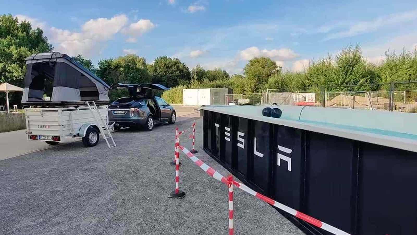 Tesla Wants You To Sit in a Wet Dumpster While Your Car Charges