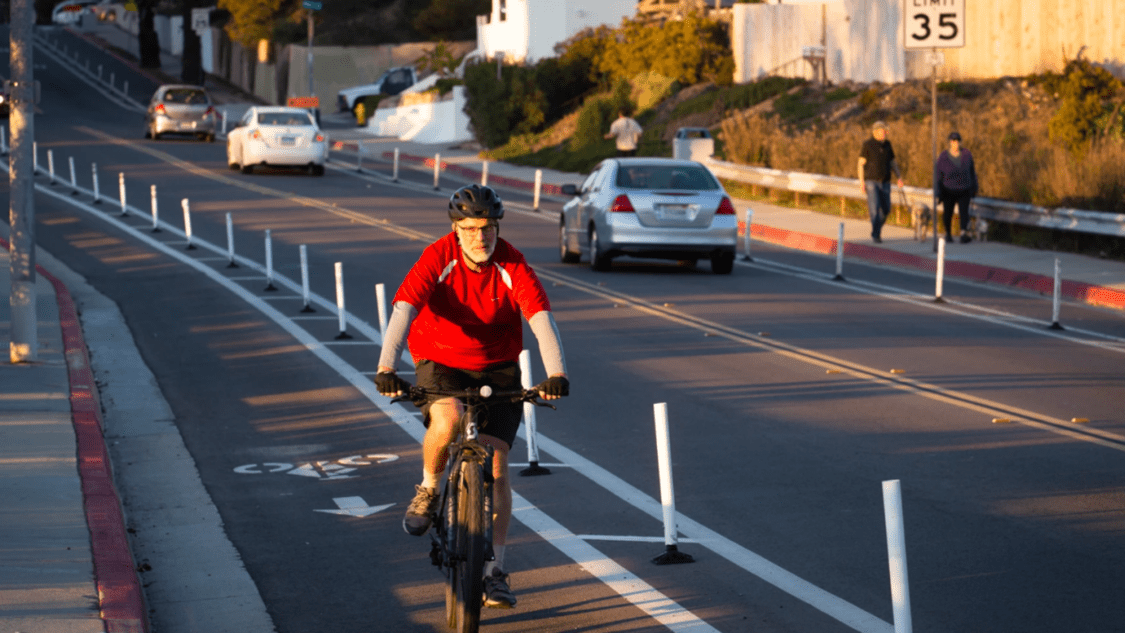 Ebike Program California. Man riding a bike in a bike lane.