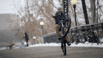 Montana E-bike policy man doing wheelie on bike