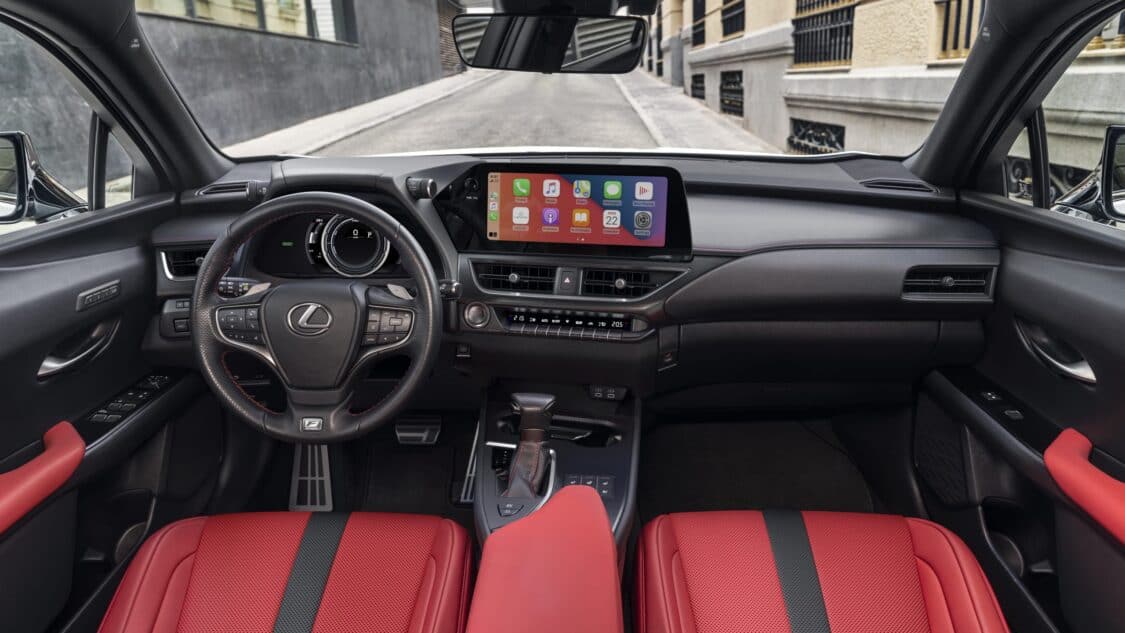 2024 Lexus UX 250h interior, F Sport steering wheel, front red seats, infotainment system