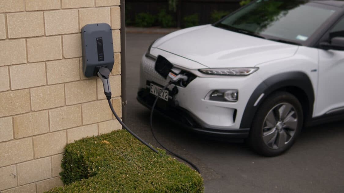 photo of white hyundai kona electric car vehicle ev charging at home charger