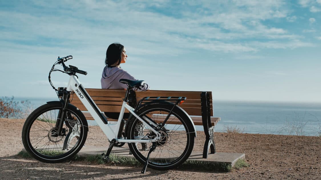 white kbo electric bike ebike woman sitting on bench looking at water