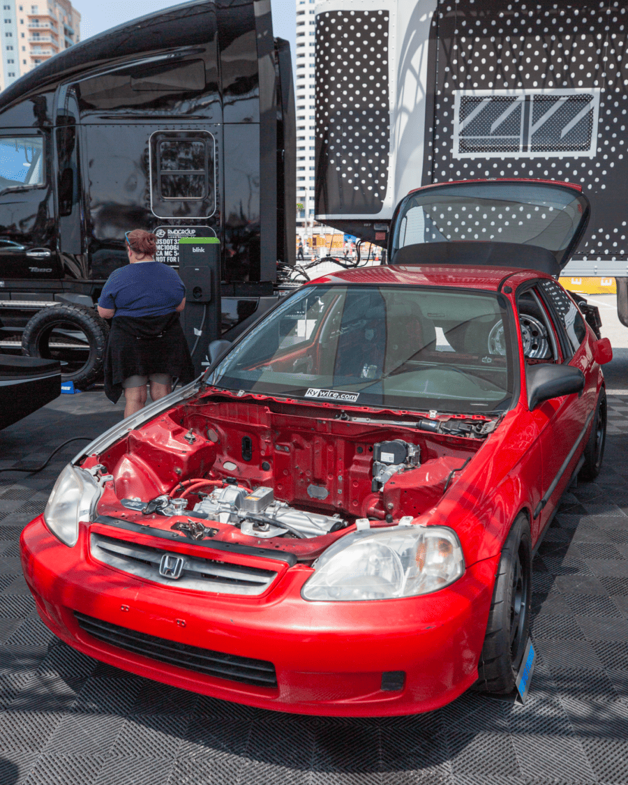 Photo of Ryan Basseri of Rywire's Telsa Honda Civic EG in the Toyo Tires booth at Electrify Expo 2023 in Long Beach