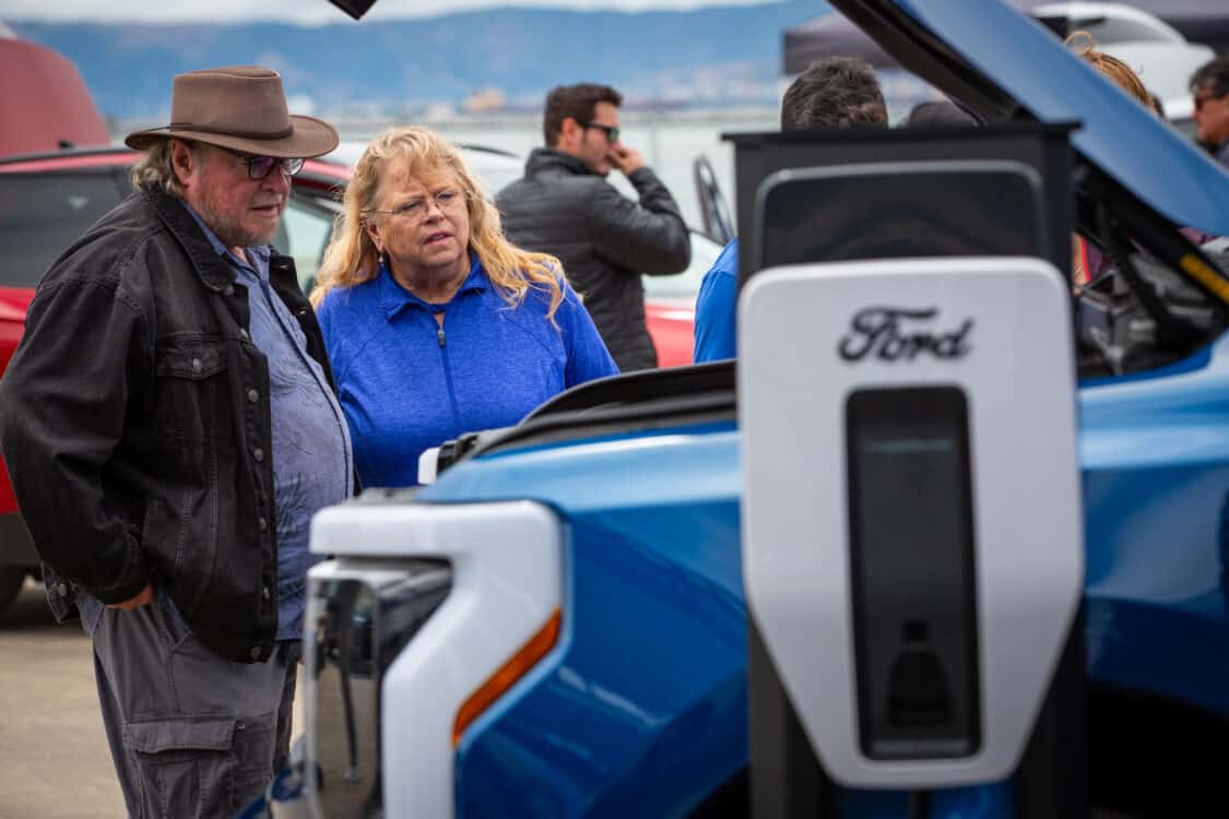 Photo of customers looking at Ford F-150 Lightning electric truck features at Electrify Expo San Francisco