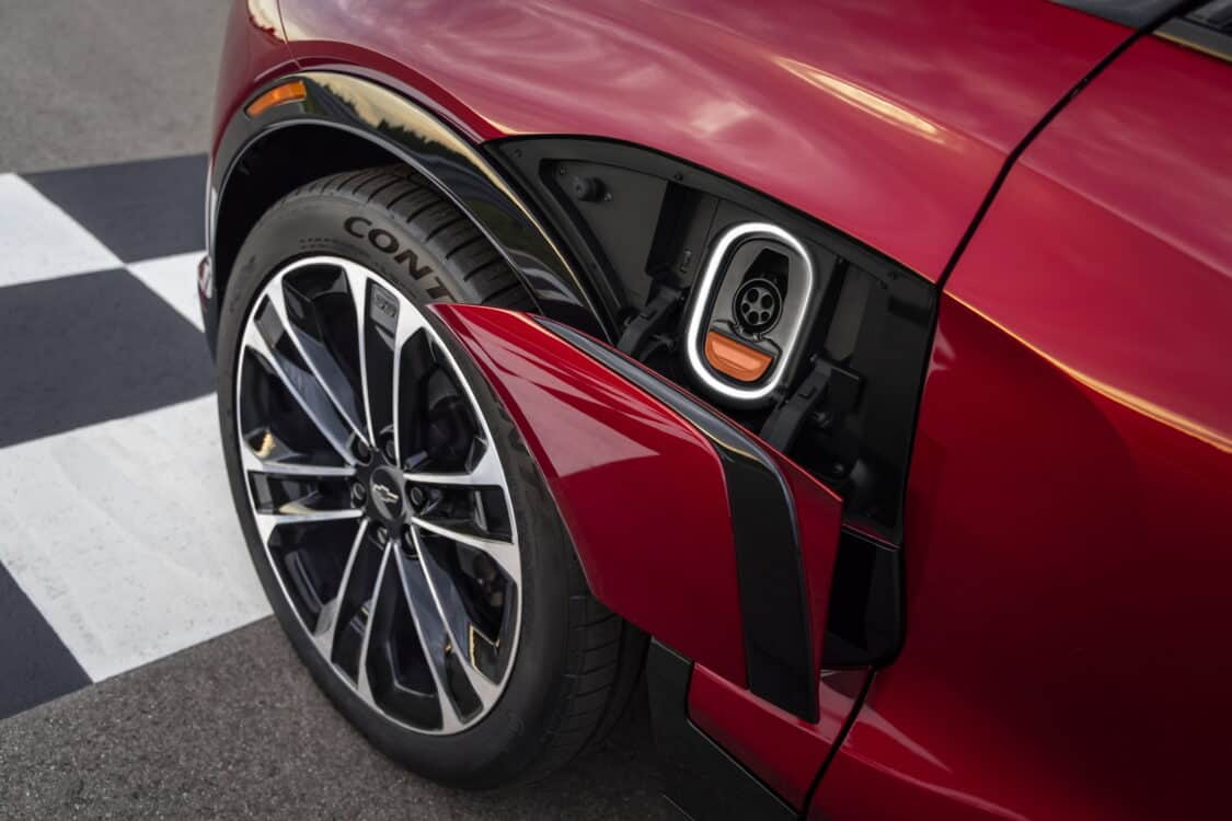 Photo of Close up of wheel and illuminated charge port on 2024 Chevrolet Blazer EV SS in Radiant Red Tintcoat. Preproduction model shown. Actual production model may vary. 2024 Chevrolet Blazer EV available Spring 2023.