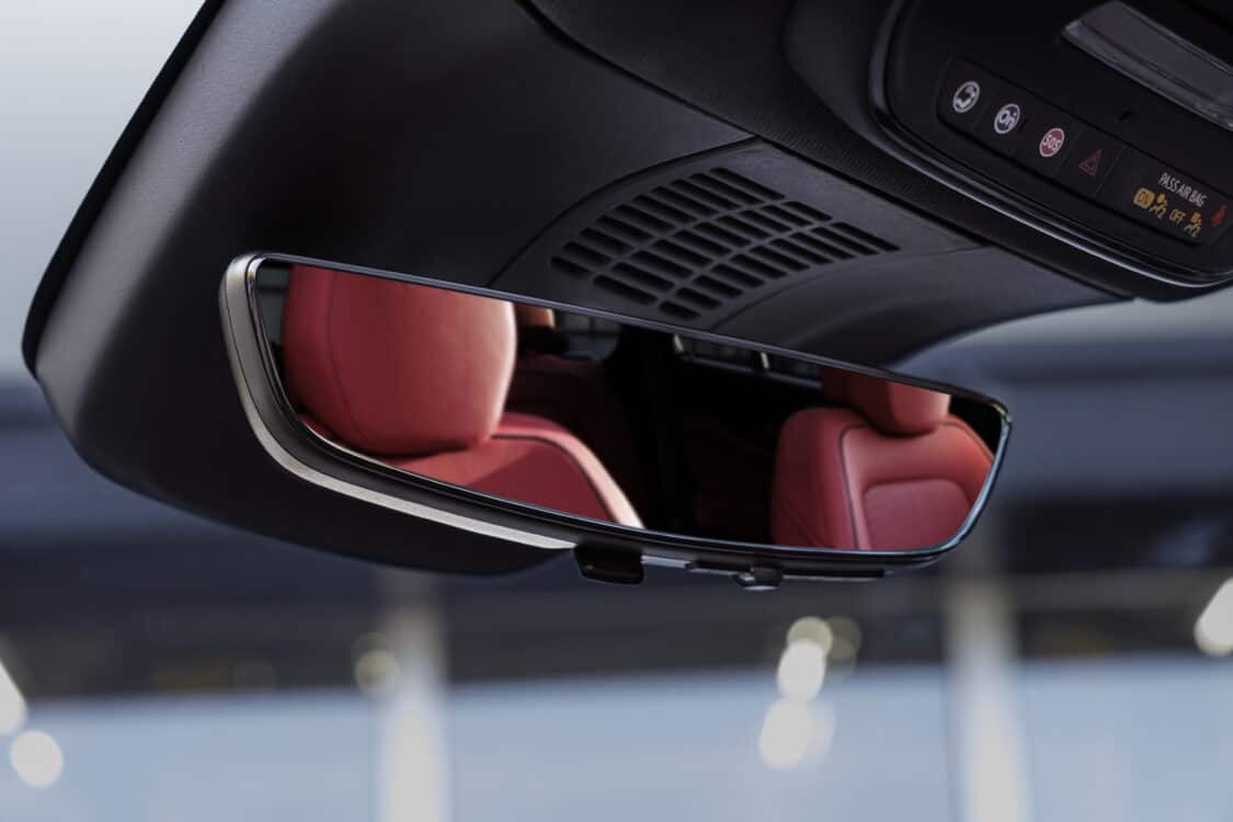 Photo of View of Adrenaline Red seats in rearview mirror of 2024 Chevrolet Blazer EV SS. Preproduction model shown. Actual production model may vary. 2024 Chevrolet Blazer EV available Spring 2023.