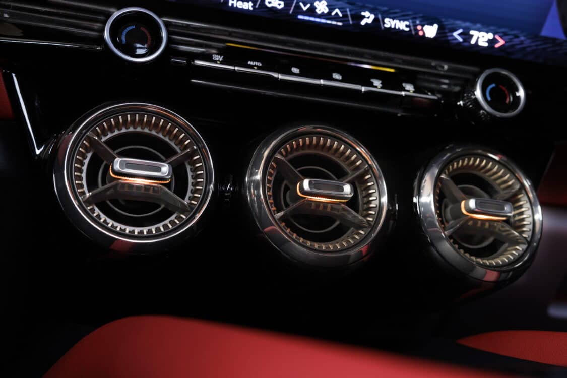 Photo of Close up of round air vents in tech bronze inside the 2024 Chevrolet Blazer EV SS in Radiant Red Tintcoat with Adrenaline Red interior. Preproduction model shown. Actual production model may vary. 2024 Chevrolet Blazer EV available Spring 2023.