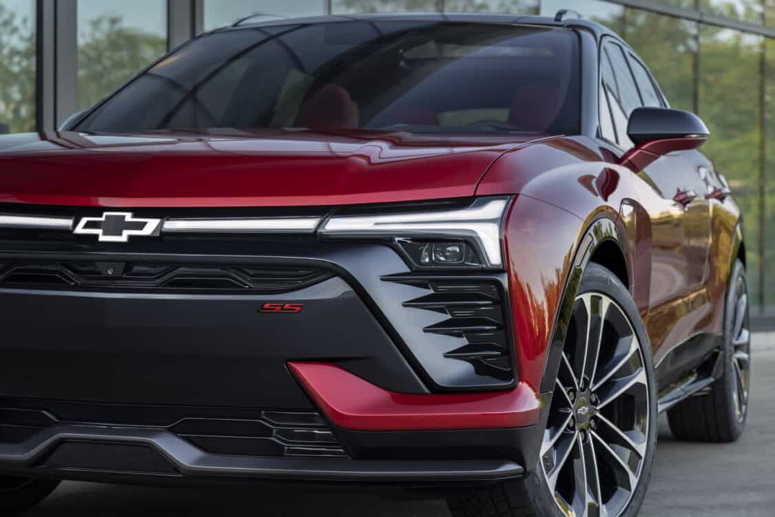 Photo of Close up of front grille, illuminated headlights and wheel on 2024 Chevrolet Blazer EV SS in Radiant Red Tintcoat. Preproduction model shown. Actual production model may vary. 2024 Chevrolet Blazer EV available Spring 2023.