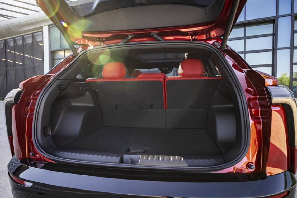 Photo of Rear view of 2024 Chevrolet Blazer EV SS in Radiant Red Tintcoat through open trunk. Preproduction model shown. Actual production model may vary. 2024 Chevrolet Blazer EV available Spring 2023.