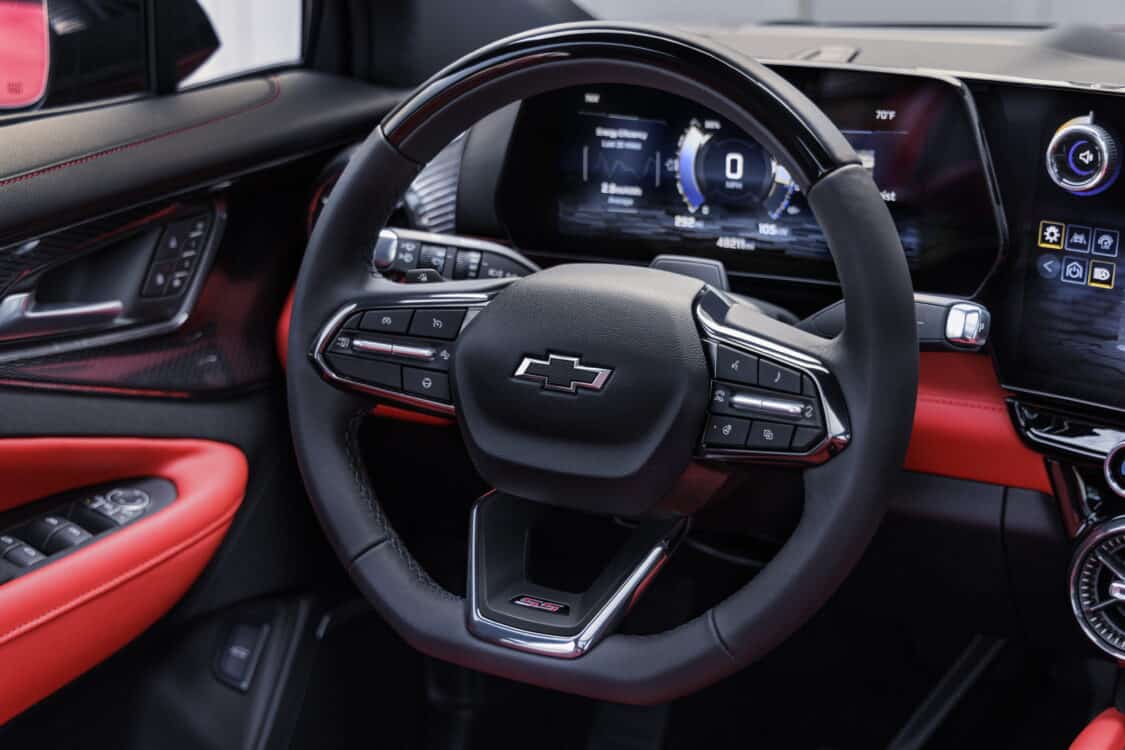 Photo of Front view of steering wheel on 2024 Chevrolet Balzer EV SS in Radiant Red Tintcoat with Adrenaline Red interior. Preproduction model shown. Actual production model may vary. 2024 Chevrolet Blazer EV available Spring 2023.