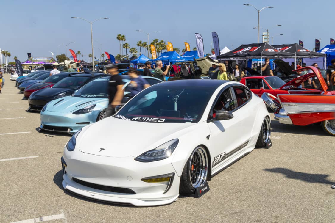 Photo of Americus Cuevas JDM VIP Bippu 2018 Tesla Model 3 LR RWD from Ruined EV modified with Thor Electronic Exhaust Management System (Dual), 
12-Volt Battery (lithium) provided by Buddy Club USA – MEGALife Battery, 19” BBS LM Wheels, Yokohama Advan Sport V107 Tires - 235/35/19 (f), 255/35/19 (r), C7 6-Piston Brembo Brake Conversion/ 370 mm BBK by Don Marconi, Universal Air Suspension Struts, Air Lift 3P Management w/ 5 gal Seamless Air Tank, VIAIR 444c Compressors (2), LOSTAR Aluminum Magnesium Alloy Skid Plates, Artisan Spirits Sports Line Black Label EVS Widebody, WellVisors Window Visors, Carbon Fiber M3 Style Side Mirrors, Electric Speed Design Carbon Fiber Mud Guards, Electric Speed Design Carbon Fiber Door Handle Covers (Painted PPW), Electric Speed Design Carbon Fiber Side Marker Covers, Robot Craftsman Multi LED Taillights (1 of 2 in the world), LowGlow Undercar LED Kit, Ghozt Lighting Module, AutoFasion Window Curtains, Broadway Mirror 300mm Convex Wide, Junction Produce Carbon VIP Tables, Junction Produce Tsuna Knot (Silver), Junction Produce Fusa Shield Emblem (Bronze), Junction Produce Katana Shift Knob 20cm (Black), Junction Produce Hannya Charm (Red Mask), Junction Produce Kyoto Fan (Black/Red), Junction Produce Tissue Box Cover (Black), Junction Produce Crystal Ashtray (Round), Junction Produce Throw Pillow Cushion (Black), Junction Produce Seat Cushion (Black), Junction Produce Missions Neck Pad V1 (Black), Junction Produce x DAD VIP Air Freshener (Crown), Air Spencer Squash x4, Electric Speed Design Carbon Fiber Dash, Electric Speed Design Carbon Fiber Window and Door Switch Kit, Electric Speed Design Carbon Fiber Center Console kit, Electric Speed Design Carbon Fiber Armrest Cover, Electric Speed Design Carbon Fiber Dome Light Covers, Electric Speed Design Carbon Fiber Stalk Covers, Inch Empire Seat and Flooring (Wine Red), Aroham D-Line Yoke Steering Wheel, Opelite Optics 600 Stars with shooting stars, Suede headliner reupholstery, Orella Acoustics Tesla Model 3 Speaker Upgrade, Hansshow 7.2” Rear Entertainment & Climate Control Display