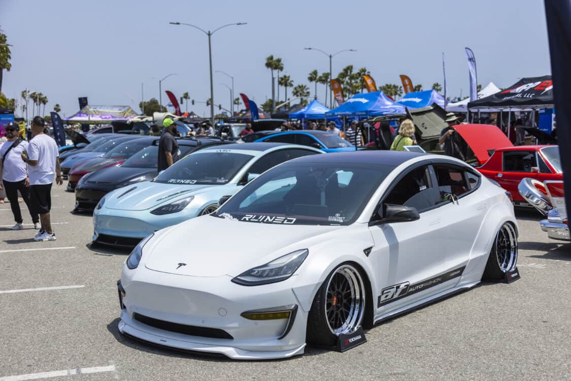 Photo of Americus Cuevas JDM VIP Bippu 2018 Tesla Model 3 LR RWD from Ruined EV modified with Thor Electronic Exhaust Management System (Dual), 12-Volt Battery (lithium) provided by Buddy Club USA – MEGALife Battery, 19” BBS LM Wheels, Yokohama Advan Sport V107 Tires - 235/35/19 (f), 255/35/19 (r), C7 6-Piston Brembo Brake Conversion/ 370 mm BBK by Don Marconi, Universal Air Suspension Struts, Air Lift 3P Management w/ 5 gal Seamless Air Tank, VIAIR 444c Compressors (2), LOSTAR Aluminum Magnesium Alloy Skid Plates, Artisan Spirits Sports Line Black Label EVS Widebody, WellVisors Window Visors, Carbon Fiber M3 Style Side Mirrors, Electric Speed Design Carbon Fiber Mud Guards, Electric Speed Design Carbon Fiber Door Handle Covers (Painted PPW), Electric Speed Design Carbon Fiber Side Marker Covers, Robot Craftsman Multi LED Taillights (1 of 2 in the world), LowGlow Undercar LED Kit, Ghozt Lighting Module, AutoFasion Window Curtains, Broadway Mirror 300mm Convex Wide, Junction Produce Carbon VIP Tables, Junction Produce Tsuna Knot (Silver), Junction Produce Fusa Shield Emblem (Bronze), Junction Produce Katana Shift Knob 20cm (Black), Junction Produce Hannya Charm (Red Mask), Junction Produce Kyoto Fan (Black/Red), Junction Produce Tissue Box Cover (Black), Junction Produce Crystal Ashtray (Round), Junction Produce Throw Pillow Cushion (Black), Junction Produce Seat Cushion (Black), Junction Produce Missions Neck Pad V1 (Black), Junction Produce x DAD VIP Air Freshener (Crown), Air Spencer Squash x4, Electric Speed Design Carbon Fiber Dash, Electric Speed Design Carbon Fiber Window and Door Switch Kit, Electric Speed Design Carbon Fiber Center Console kit, Electric Speed Design Carbon Fiber Armrest Cover, Electric Speed Design Carbon Fiber Dome Light Covers, Electric Speed Design Carbon Fiber Stalk Covers, Inch Empire Seat and Flooring (Wine Red), Aroham D-Line Yoke Steering Wheel, Opelite Optics 600 Stars with shooting stars, Suede headliner reupholstery, Orella Acoustics Tesla Model 3 Speaker Upgrade, Hansshow 7.2” Rear Entertainment & Climate Control Display