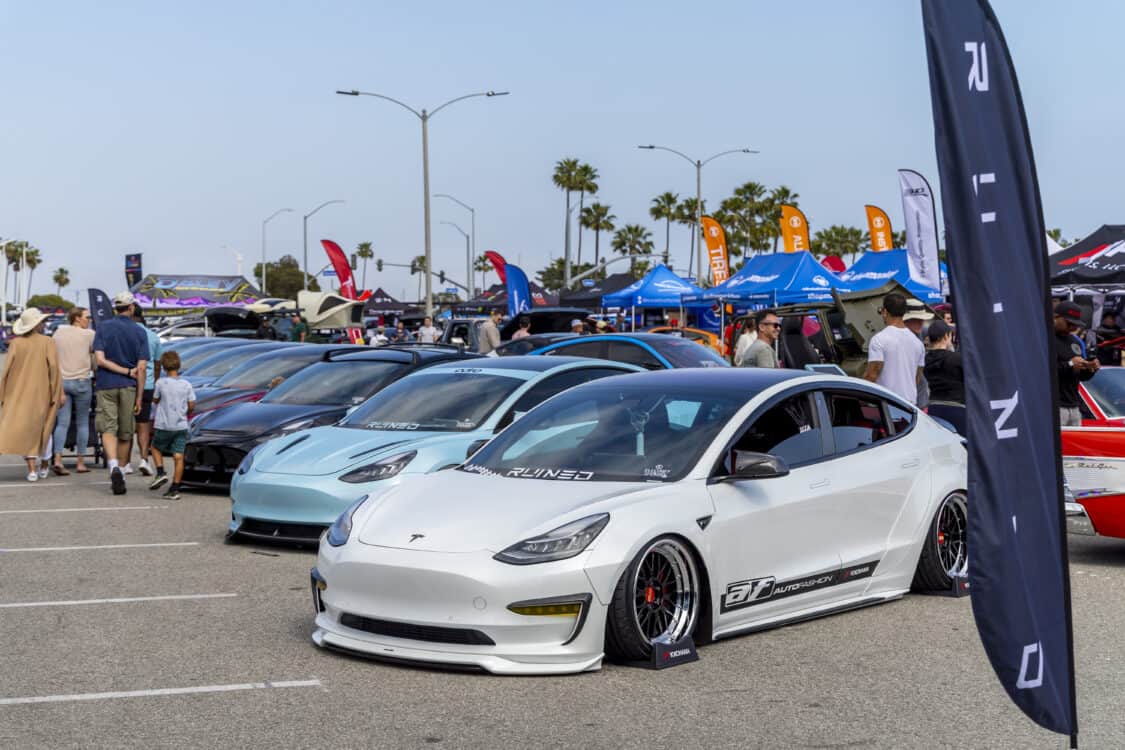 Photo of Americus Cuevas JDM VIP Bippu 2018 Tesla Model 3 LR RWD from Ruined EV modified with Thor Electronic Exhaust Management System (Dual), 12-Volt Battery (lithium) provided by Buddy Club USA – MEGALife Battery, 19” BBS LM Wheels, Yokohama Advan Sport V107 Tires - 235/35/19 (f), 255/35/19 (r), C7 6-Piston Brembo Brake Conversion/ 370 mm BBK by Don Marconi, Universal Air Suspension Struts, Air Lift 3P Management w/ 5 gal Seamless Air Tank, VIAIR 444c Compressors (2), LOSTAR Aluminum Magnesium Alloy Skid Plates, Artisan Spirits Sports Line Black Label EVS Widebody, WellVisors Window Visors, Carbon Fiber M3 Style Side Mirrors, Electric Speed Design Carbon Fiber Mud Guards, Electric Speed Design Carbon Fiber Door Handle Covers (Painted PPW), Electric Speed Design Carbon Fiber Side Marker Covers, Robot Craftsman Multi LED Taillights (1 of 2 in the world), LowGlow Undercar LED Kit, Ghozt Lighting Module, AutoFasion Window Curtains, Broadway Mirror 300mm Convex Wide, Junction Produce Carbon VIP Tables, Junction Produce Tsuna Knot (Silver), Junction Produce Fusa Shield Emblem (Bronze), Junction Produce Katana Shift Knob 20cm (Black), Junction Produce Hannya Charm (Red Mask), Junction Produce Kyoto Fan (Black/Red), Junction Produce Tissue Box Cover (Black), Junction Produce Crystal Ashtray (Round), Junction Produce Throw Pillow Cushion (Black), Junction Produce Seat Cushion (Black), Junction Produce Missions Neck Pad V1 (Black), Junction Produce x DAD VIP Air Freshener (Crown), Air Spencer Squash x4, Electric Speed Design Carbon Fiber Dash, Electric Speed Design Carbon Fiber Window and Door Switch Kit, Electric Speed Design Carbon Fiber Center Console kit, Electric Speed Design Carbon Fiber Armrest Cover, Electric Speed Design Carbon Fiber Dome Light Covers, Electric Speed Design Carbon Fiber Stalk Covers, Inch Empire Seat and Flooring (Wine Red), Aroham D-Line Yoke Steering Wheel, Opelite Optics 600 Stars with shooting stars, Suede headliner reupholstery, Orella Acoustics Tesla Model 3 Speaker Upgrade, Hansshow 7.2” Rear Entertainment & Climate Control Display