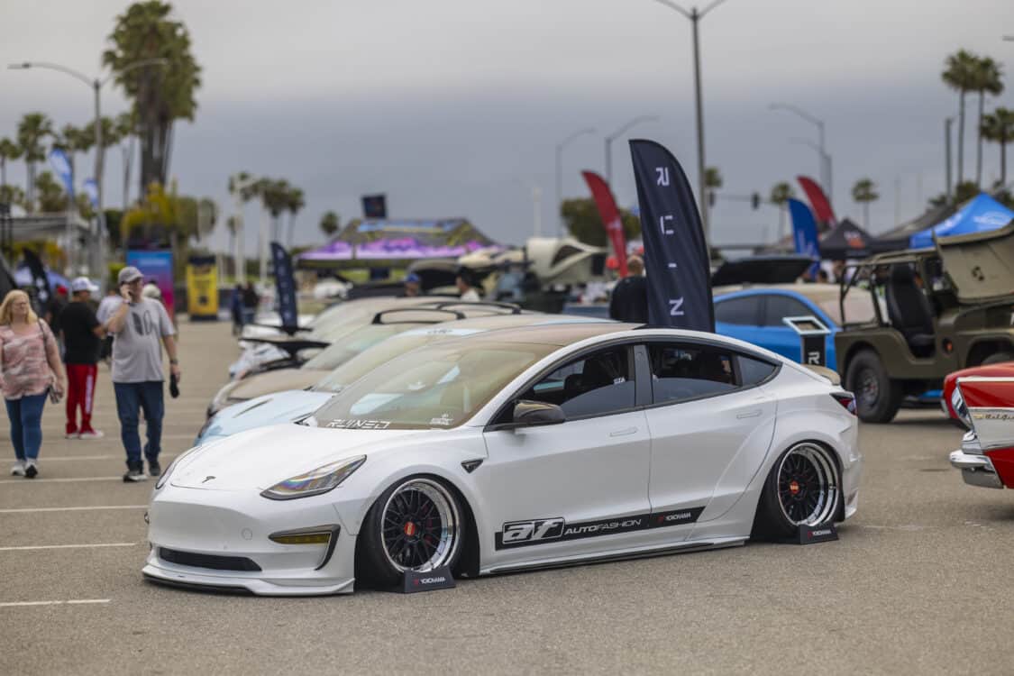 Photo of Americus Cuevas JDM VIP Bippu 2018 Tesla Model 3 LR RWD from Ruined EV modified with Thor Electronic Exhaust Management System (Dual), 12-Volt Battery (lithium) provided by Buddy Club USA – MEGALife Battery, 19” BBS LM Wheels, Yokohama Advan Sport V107 Tires - 235/35/19 (f), 255/35/19 (r), C7 6-Piston Brembo Brake Conversion/ 370 mm BBK by Don Marconi, Universal Air Suspension Struts, Air Lift 3P Management w/ 5 gal Seamless Air Tank, VIAIR 444c Compressors (2), LOSTAR Aluminum Magnesium Alloy Skid Plates, Artisan Spirits Sports Line Black Label EVS Widebody, WellVisors Window Visors, Carbon Fiber M3 Style Side Mirrors, Electric Speed Design Carbon Fiber Mud Guards, Electric Speed Design Carbon Fiber Door Handle Covers (Painted PPW), Electric Speed Design Carbon Fiber Side Marker Covers, Robot Craftsman Multi LED Taillights (1 of 2 in the world), LowGlow Undercar LED Kit, Ghozt Lighting Module, AutoFasion Window Curtains, Broadway Mirror 300mm Convex Wide, Junction Produce Carbon VIP Tables, Junction Produce Tsuna Knot (Silver), Junction Produce Fusa Shield Emblem (Bronze), Junction Produce Katana Shift Knob 20cm (Black), Junction Produce Hannya Charm (Red Mask), Junction Produce Kyoto Fan (Black/Red), Junction Produce Tissue Box Cover (Black), Junction Produce Crystal Ashtray (Round), Junction Produce Throw Pillow Cushion (Black), Junction Produce Seat Cushion (Black), Junction Produce Missions Neck Pad V1 (Black), Junction Produce x DAD VIP Air Freshener (Crown), Air Spencer Squash x4, Electric Speed Design Carbon Fiber Dash, Electric Speed Design Carbon Fiber Window and Door Switch Kit, Electric Speed Design Carbon Fiber Center Console kit, Electric Speed Design Carbon Fiber Armrest Cover, Electric Speed Design Carbon Fiber Dome Light Covers, Electric Speed Design Carbon Fiber Stalk Covers, Inch Empire Seat and Flooring (Wine Red), Aroham D-Line Yoke Steering Wheel, Opelite Optics 600 Stars with shooting stars, Suede headliner reupholstery, Orella Acoustics Tesla Model 3 Speaker Upgrade, Hansshow 7.2” Rear Entertainment & Climate Control Display