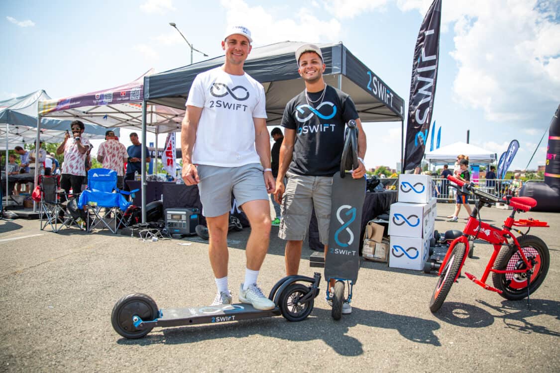 Photo of attendees test riding 2swift electric skateboard at Electrify Expo in New York