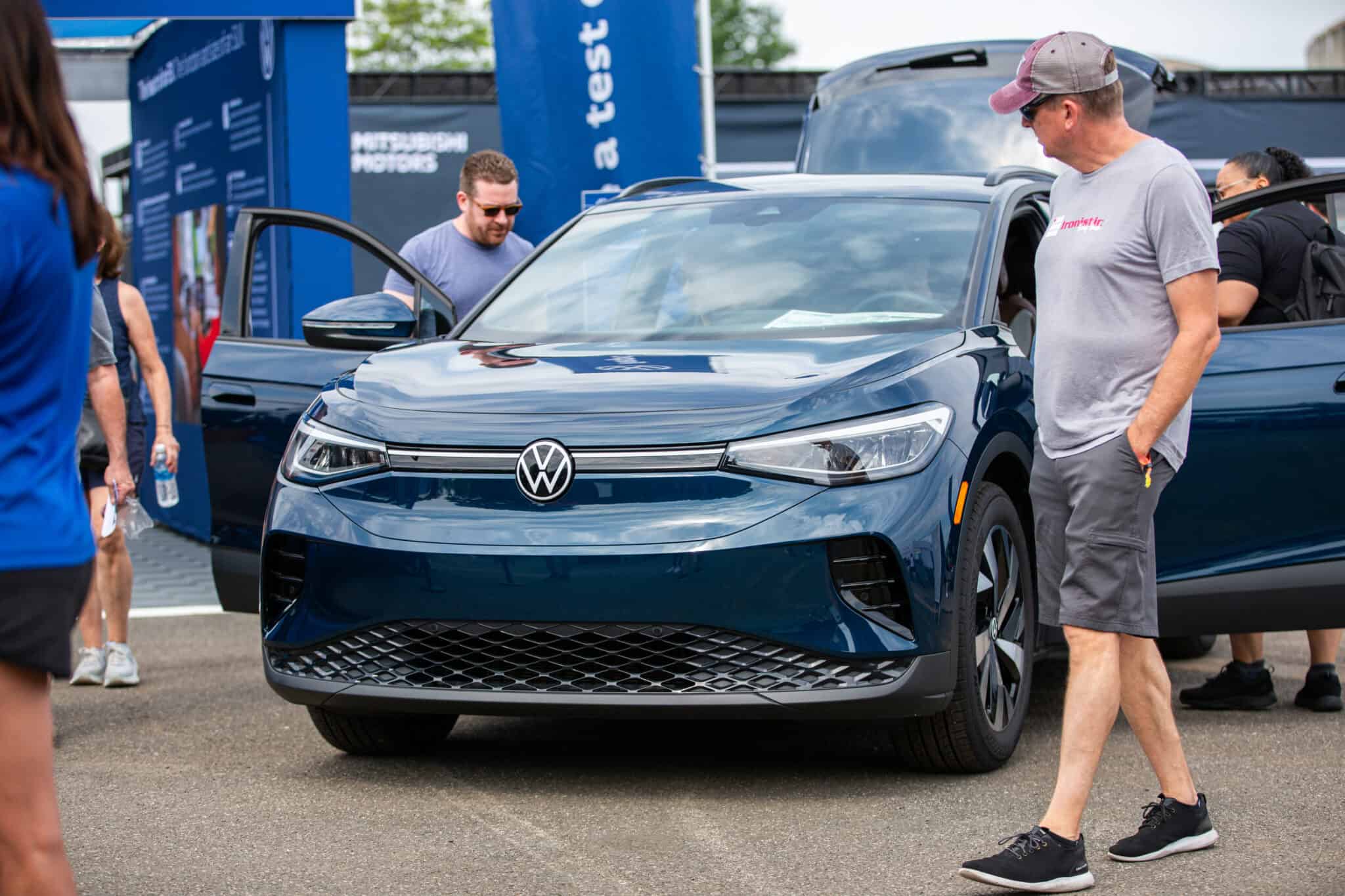 Volkswagen ID.4 at Electrify Expo with attendees exploring the vehicle.