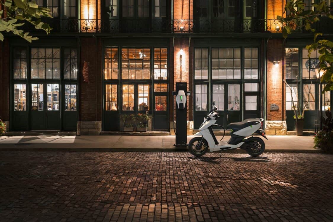 Electric motorcycle market - Ather energy charging on the street.