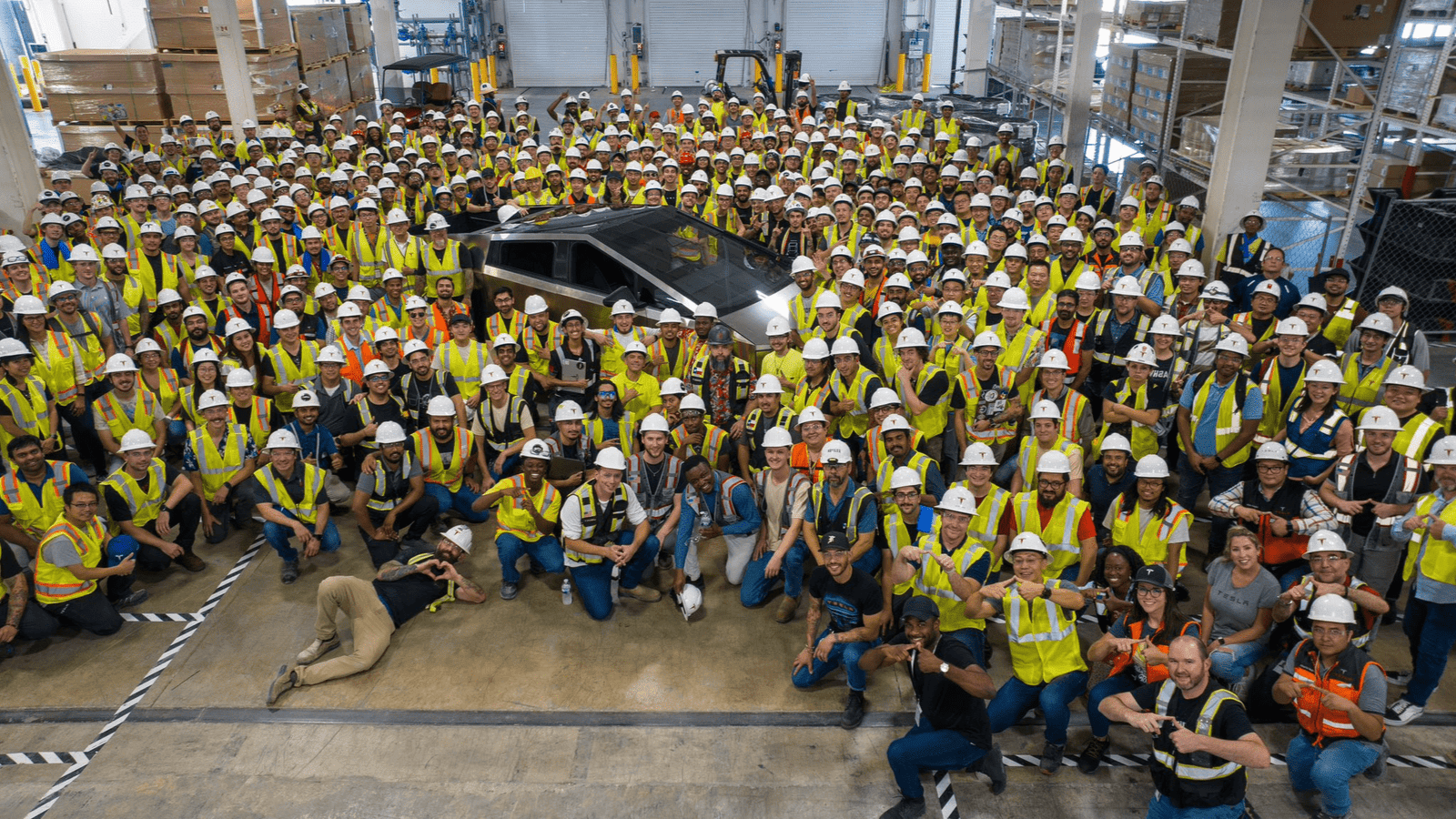 Photo of the first Tesla Cybertruck build at the Giga Austin Texas Factory. Workers express excitement.