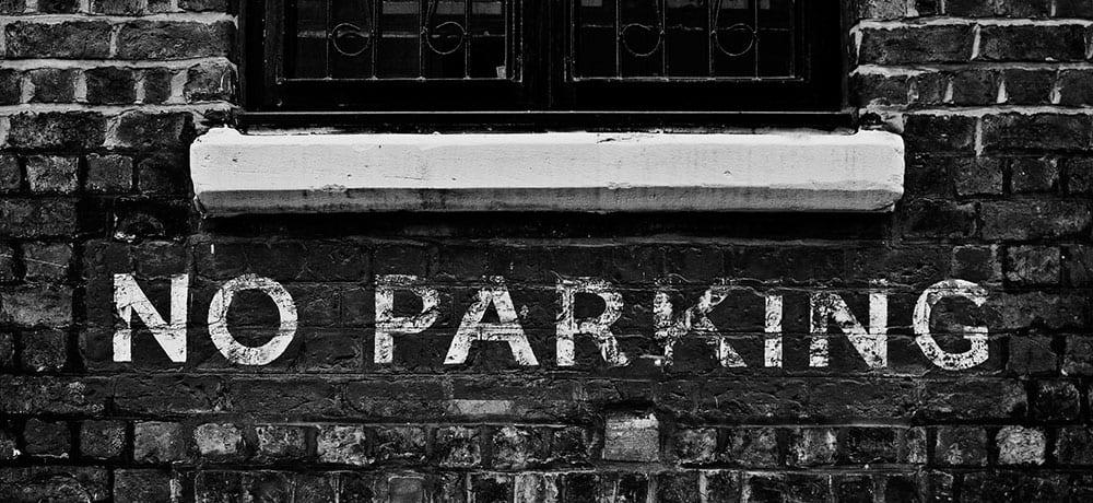 No Parking painted on a brick wall, xtraspots could open these spots up