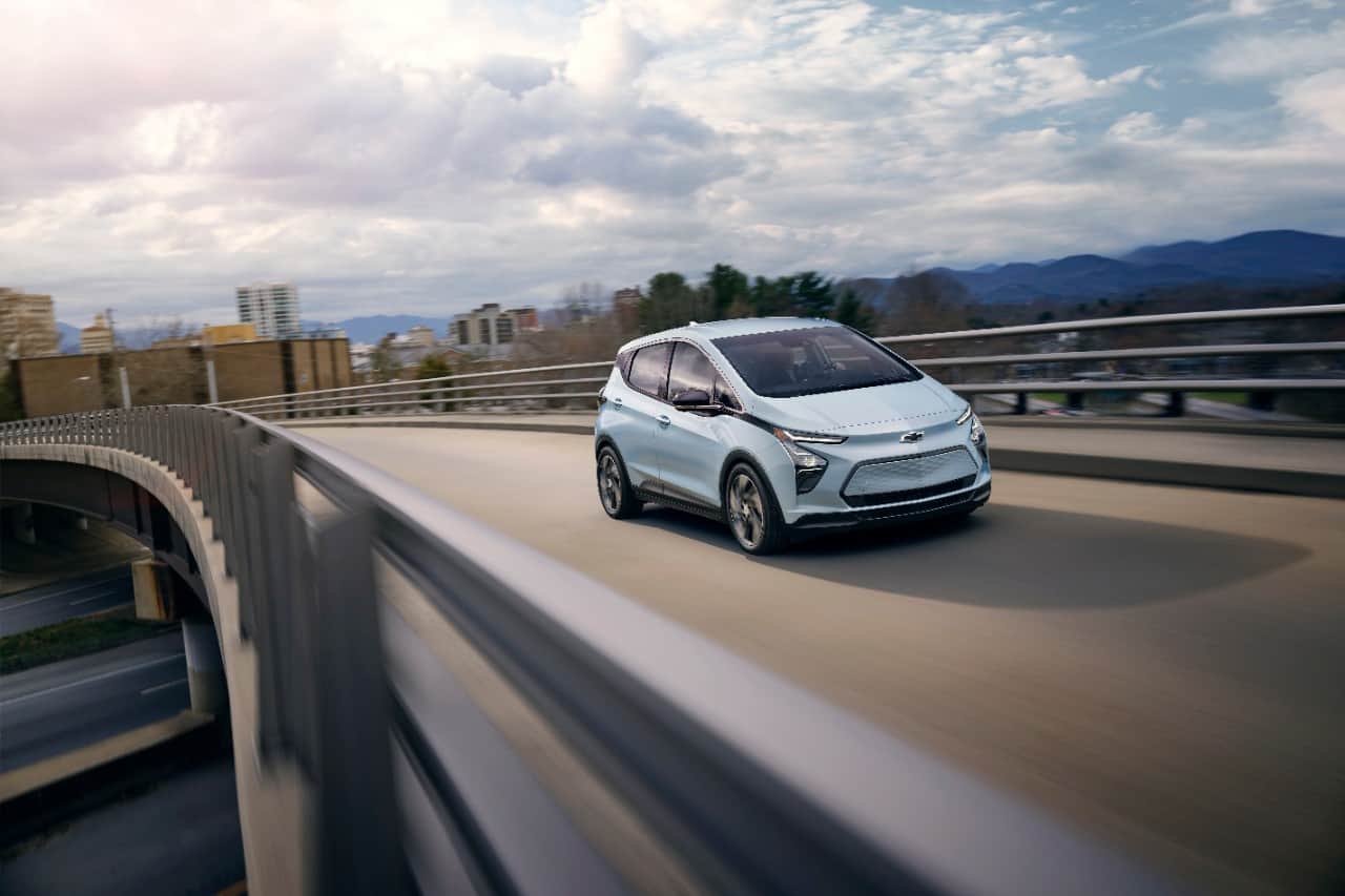 Photo of 2023 Bolt EV front three-quarter driving on an overpass