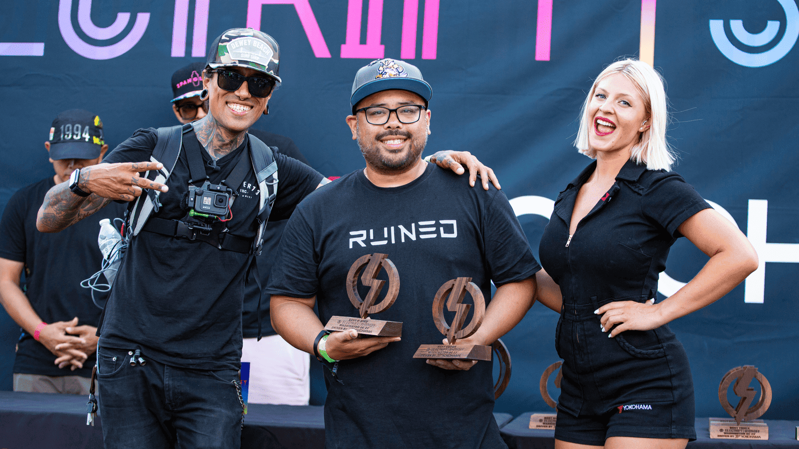 Photo of David Perez and AJ Velasco of RUINED EV accepting award for Best Crew with Yokohama car model at Electrify Showoff in Washington, DC.