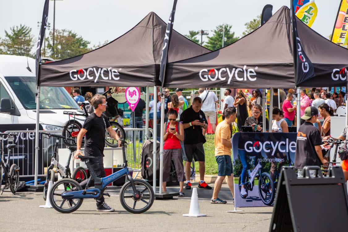 Photo of attendees test riding GoCycle electric bikes at Electrify Expo in New York