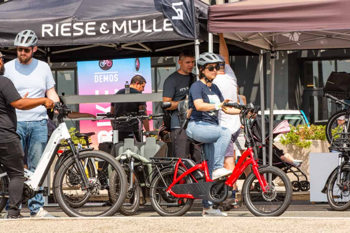 Photo of attendees test riding Riese & Muller electric bikes at Electrify Expo in New York