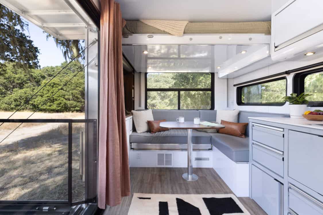 Image showcasing the kitchen and living space of the Living Vehicle HD24 all-electric luxury trailer off-grid