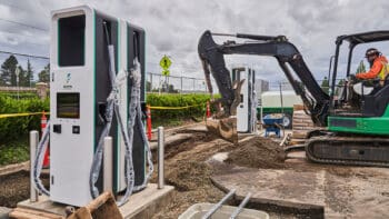 a broken EV charger being replaced with new units, excavator digging around them