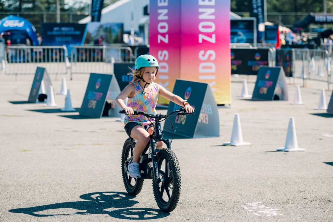 Image showcasing kid riding Stacyc e-bike at Electrify Expo Seattle