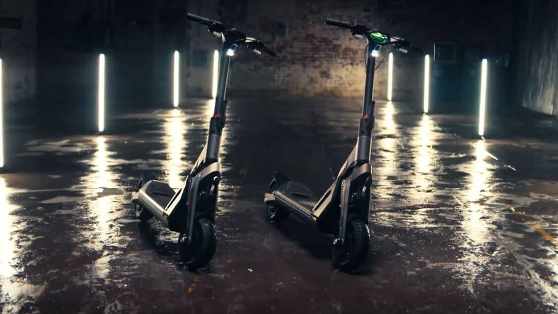 two Segway SuperScooter GT2 in an industrial looking room with wet floors