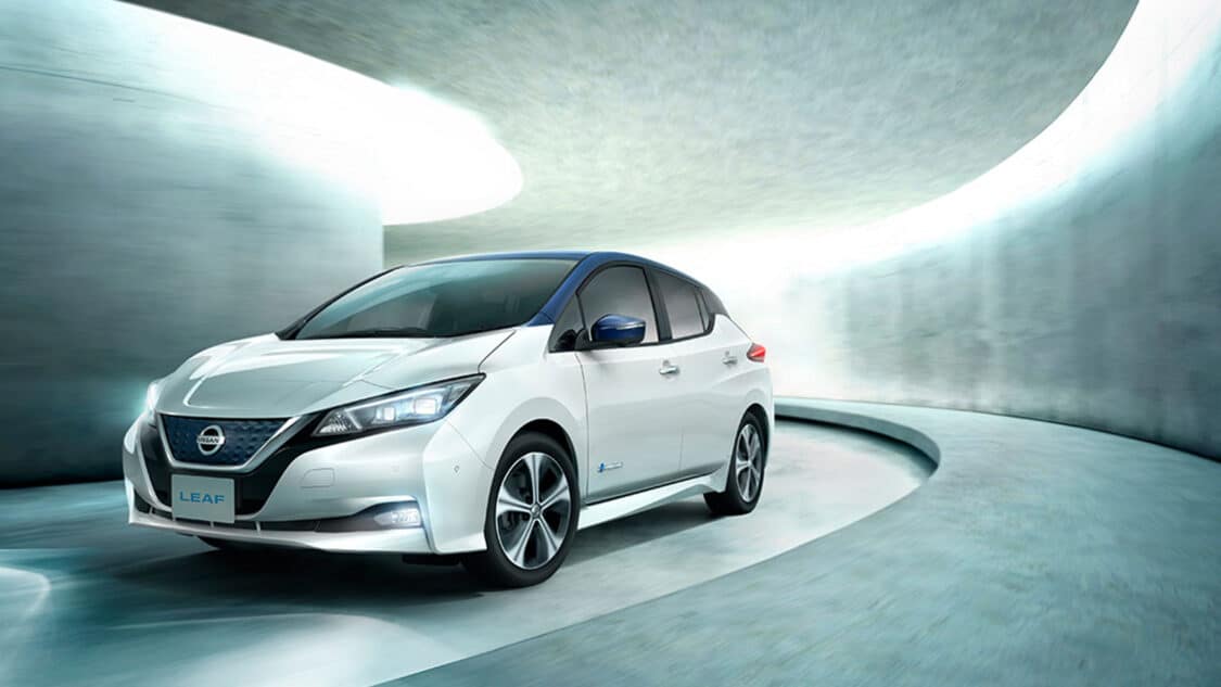white 2024 Nissan Leaf is tax eligible. Driving through a curved tunnel