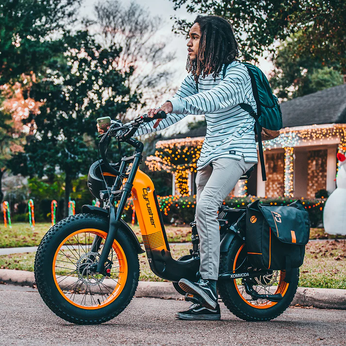 Image showcasing Cyrusher Kommoda electric bike in orange with rider