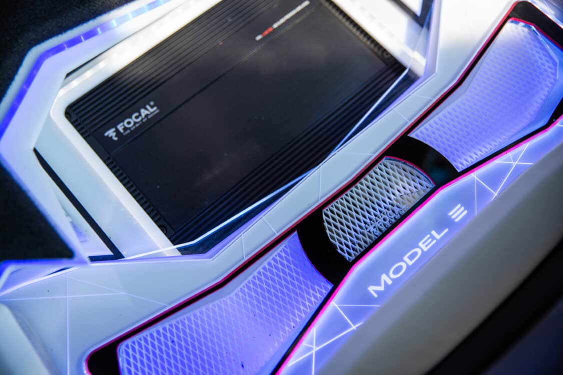 Image showcasing AJ Velasco 2020 Tesla Model 3 Performance Focal Audio custom car audio setup at Electrify Expo Showoff in the Meguiar's booth