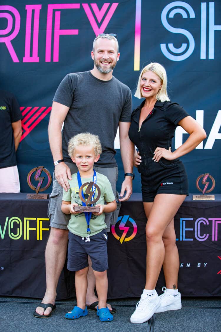 Image showcasing Jeff Blake and his son accepting the award of Best SUV at Electrify Showoff in Washington, DC, with Yokohama Tire spokesmodel