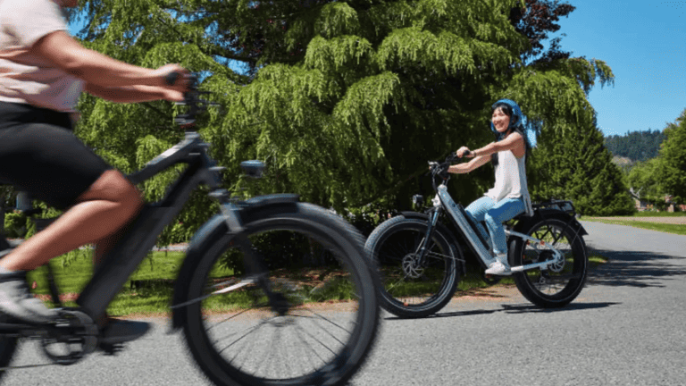 Image showcasing woman riding the Rad Power RadRover 6 Plus Electric Fat Tire Bike Charcoal Step-Thru