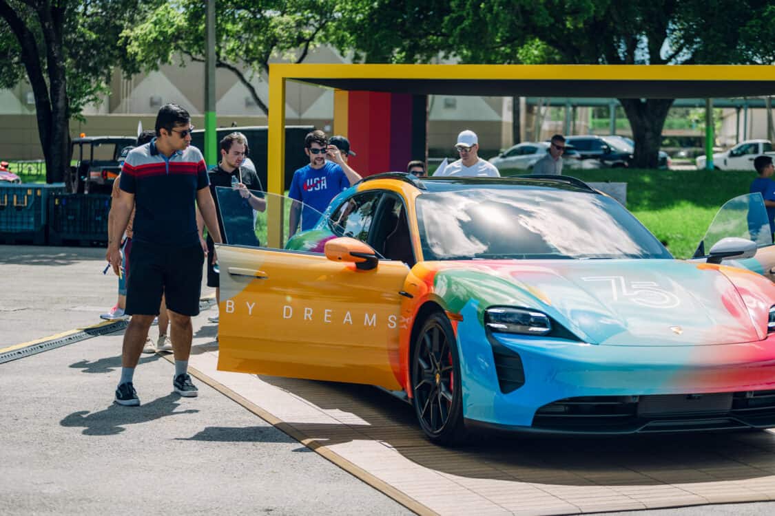 Image showcasing excited attendees for the Porsche Taycan at Electrify Expo Miami