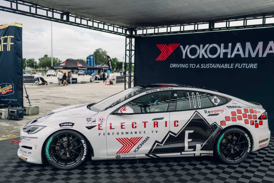 Image showcasing Best Performance presented by Borla award with Blake Fuller and his Tesla Model 3 in the Yokohama Tire booth