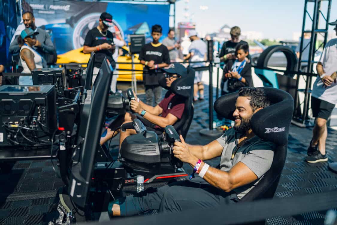 Image showcasing racing game simulators in Hankook Tire booth at Electrify Showoff in Miami