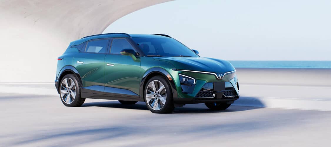 Image showcasing VinFast VF 7 electric SUV in green