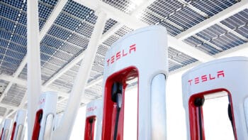 Tesla NACS supercharger station with close up of a charger