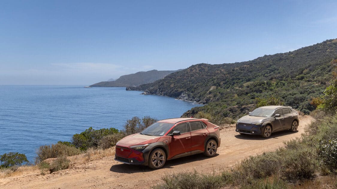 Two Subaru Solterra overlooking the ocean, soon to be NACS compatible