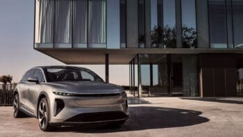Lucid Gravity parked in front of a building with modern architecture