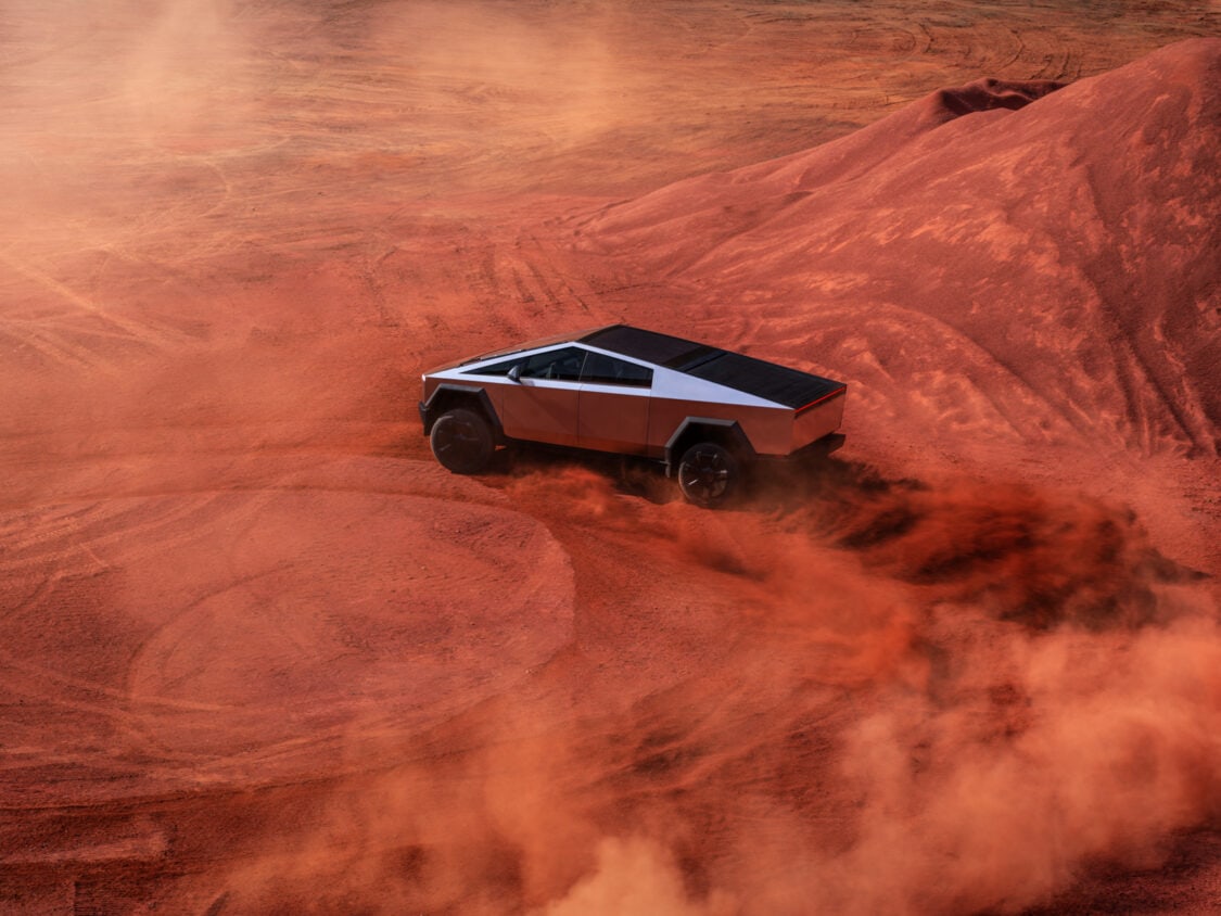 Image showcasing 2024 Tesla Cybertruck drifting in desert