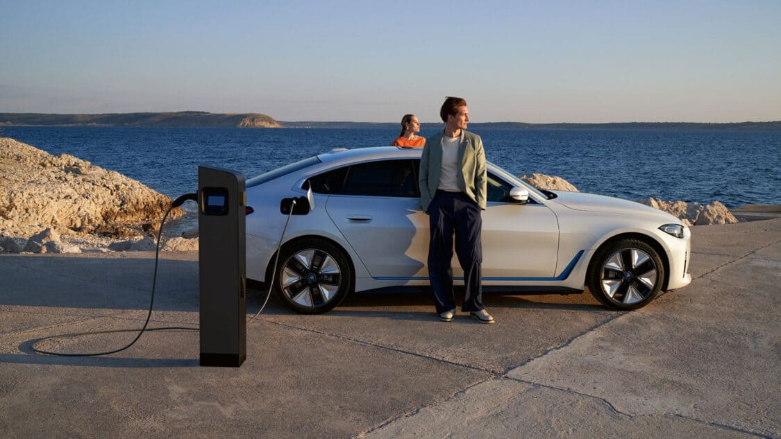 BMW charging next to body of water