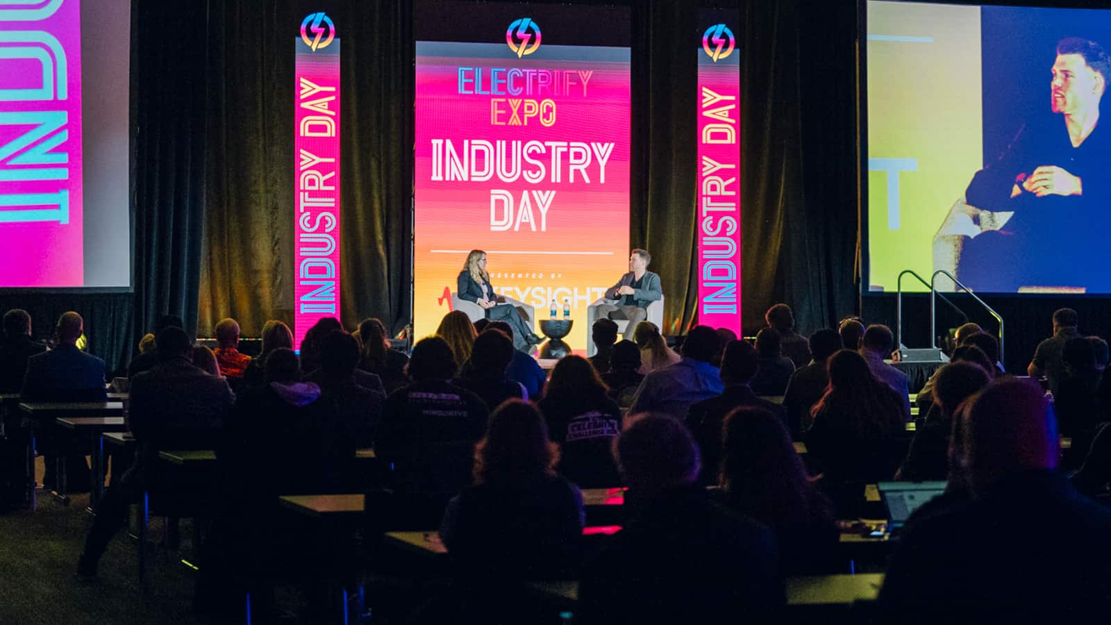 Image showcasing Marvin C. Kroger, Electric Vehicle Business Development Manager at Keysight Technologies, and Jennifer Hiller, Energy Reporter from The Wall Street Journal, engaged in a fireside chat about V2G technology at Electrify Expo Industry Day in Austin, TX 2023