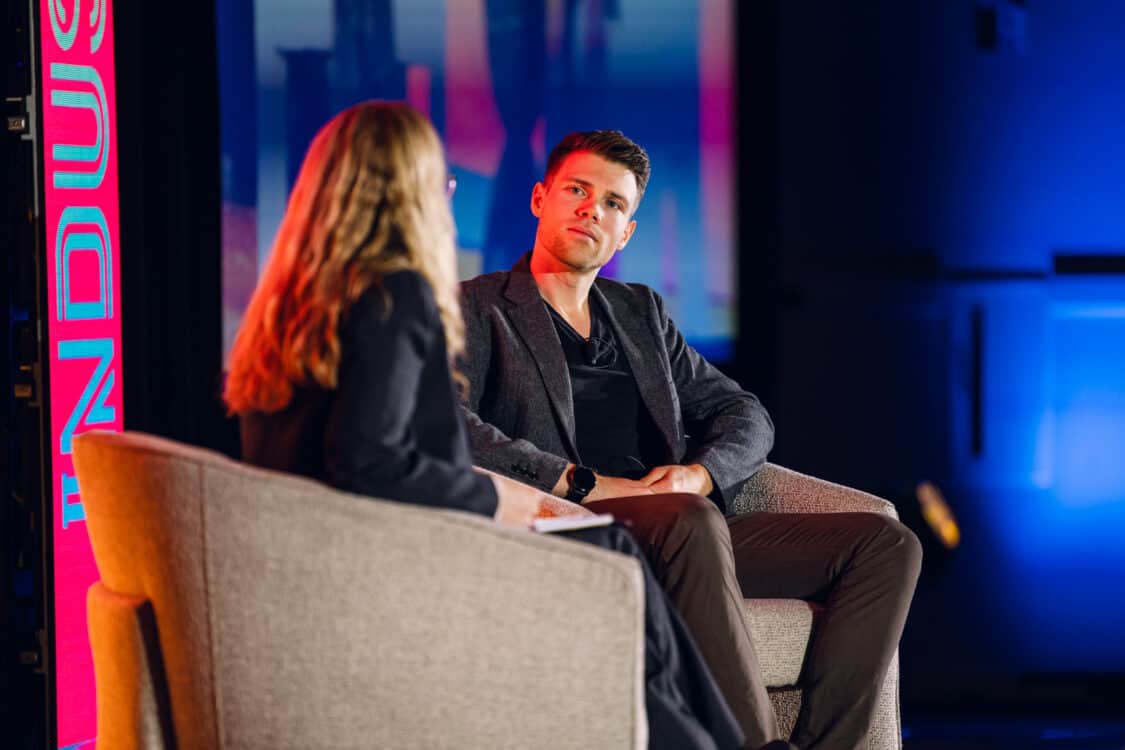 Image showcasing Marvin C. Kroger, Electric Vehicle Business Development Manager at Keysight Technologies, and Jennifer Hiller, Energy Reporter from The Wall Street Journal, engaged in a fireside chat about V2G technology at Electrify Expo Industry Day in Austin, TX 2023