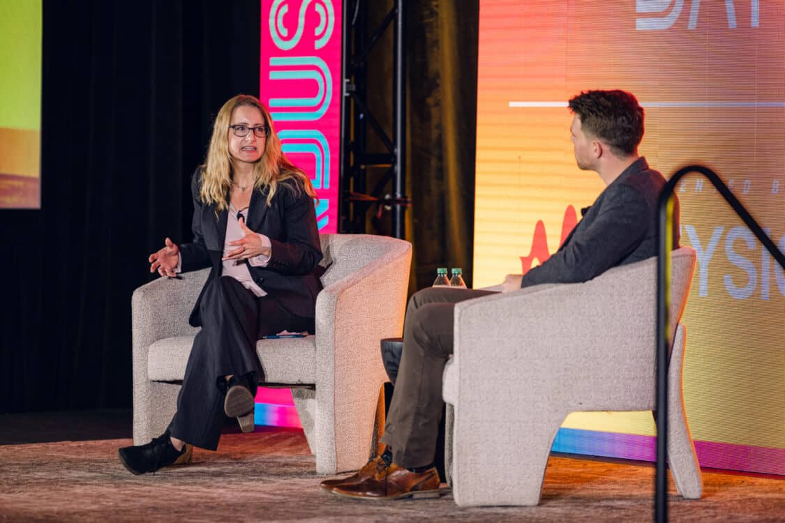 Image showcasing Marvin C. Kroger, Electric Vehicle Business Development Manager at Keysight Technologies, and Jennifer Hiller, Energy Reporter from The Wall Street Journal, engaged in a fireside chat about V2G technology at Electrify Expo Industry Day in Austin, TX 2023