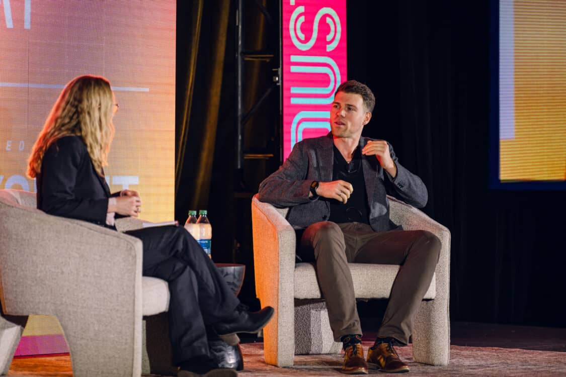 Image showcasing Marvin C. Kroger, Electric Vehicle Business Development Manager at Keysight Technologies, and Jennifer Hiller, Energy Reporter from The Wall Street Journal, engaged in a fireside chat about V2G technology at Electrify Expo Industry Day in Austin, TX 2023