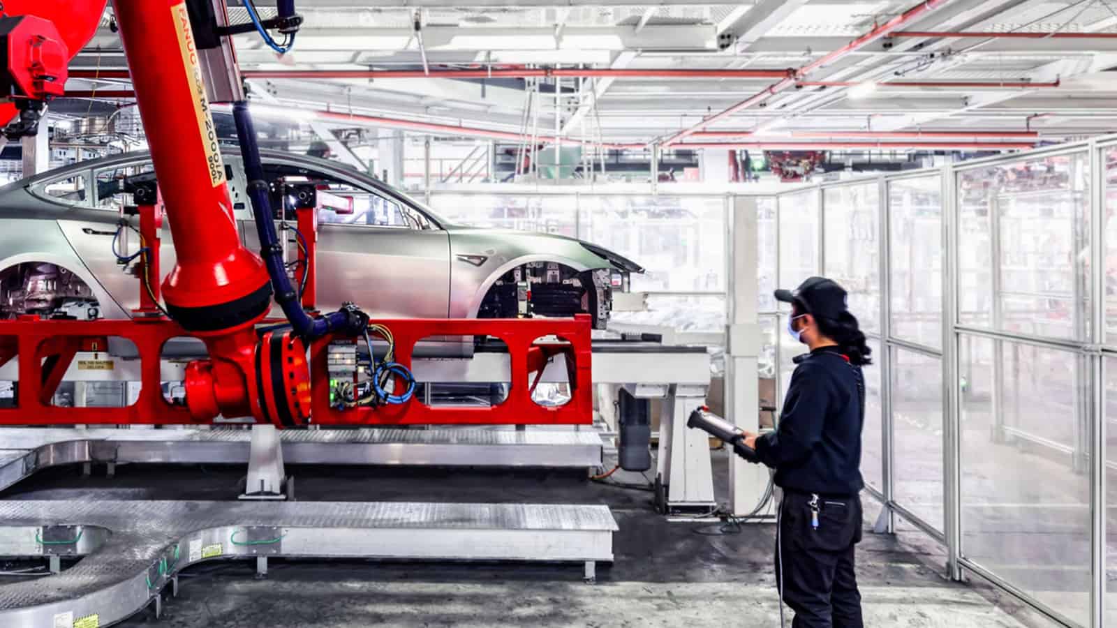 Tesla automaker employee working on a car